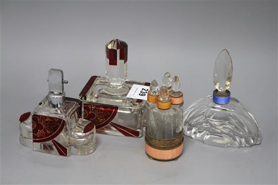 An Eastern European ruby overlaid glass scent flask and matching casket, a cut glass scent bottle with blue enamelled collar and